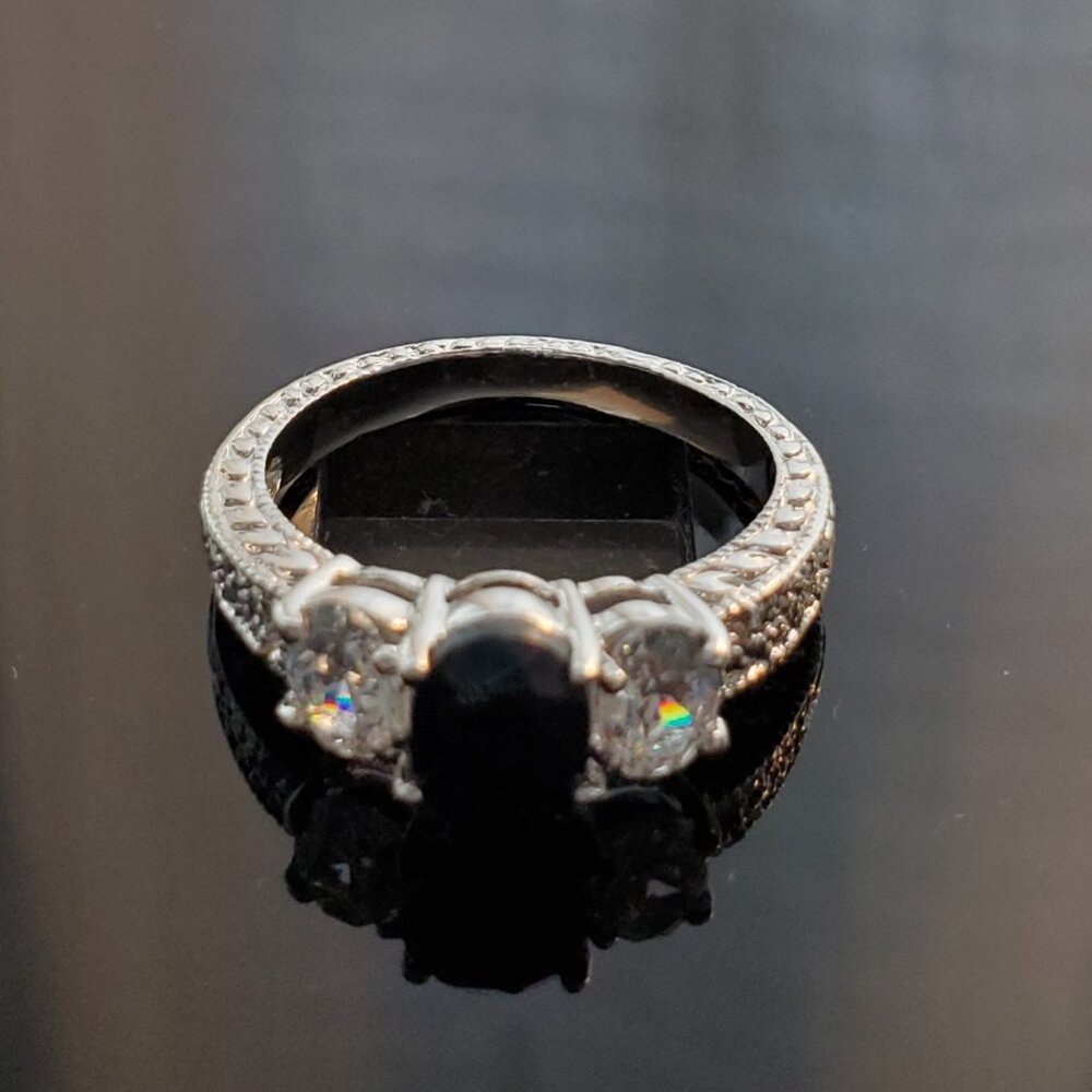Silver ring with black oval cut gemstone
